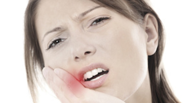 A picture of a young woman with a terrible toothache