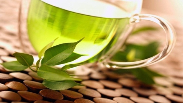 healthy green tea cup with tea leaves